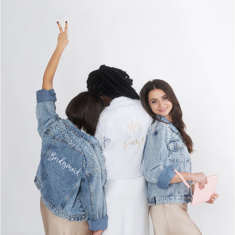 Personalized bridal denim jacket. Made from soft denim and decorated with faux pearls for a chic look. White jean jacket custom embroidered with your name. Perfect to wear for an engagement photoshoot.