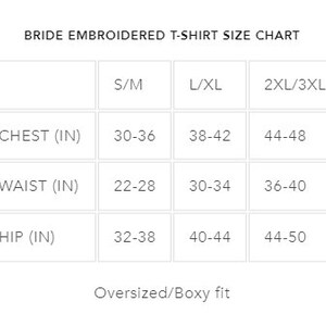 May include: Bride embroidered t-shirt size chart with measurements in inches for chest, waist, and hip. Sizes include S/M, L/XL, and 2XL/3XL. The chart indicates an oversized/boxy fit.