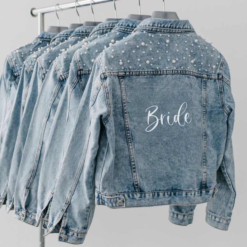 Personalized bridal denim jacket. Made from soft denim and decorated with faux pearls for a chic look. Jean jacket custom embroidered with your name. Perfect to wear for an engagement photoshoot.