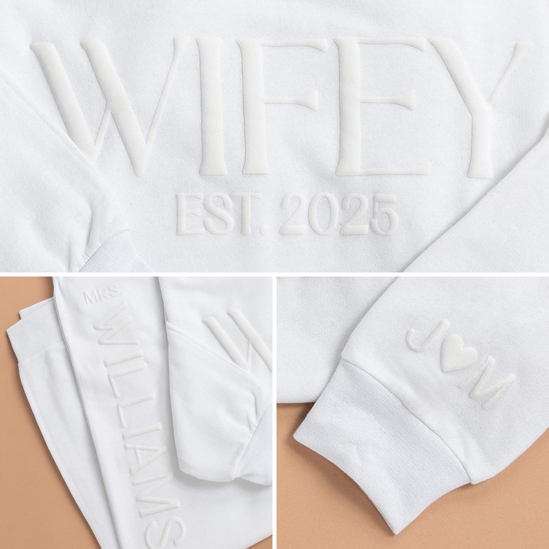 May include: White sweatshirt with the text "WIFEY EST. 2025" on the front and the text "MRS. WILLIAMS" on the sleeve. The sweatshirt also has a heart with the letter "J" on the other sleeve.