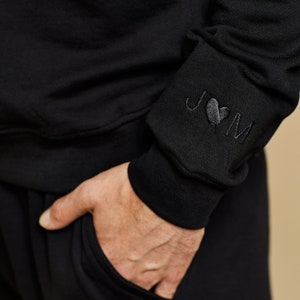 Initials with heart on the sleeve of Groom sweatshirt