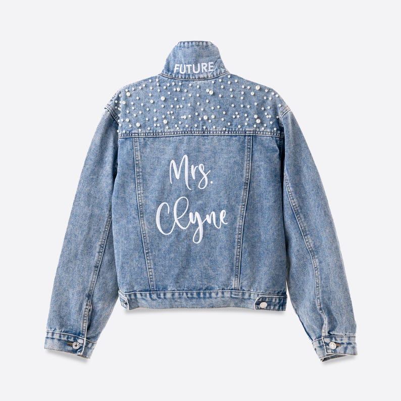 Personalized bridal denim jacket. Made from soft denim and decorated with faux pearls for a chic look. White jean jacket custom embroidered with your name. Perfect to wear for an engagement photoshoot.
