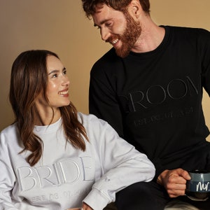 Matching Sweatshirts For Bride and Groom. Can be personalized on the cuff and chest with Premium Embroidery. Engagement Gift For Couple