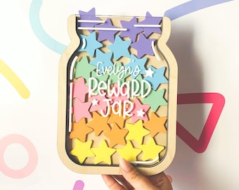 May include: A wooden reward jar with a clear front, featuring a rainbow of colorful stars. The jar is personalized with the name "Evelyn's Reward Jar".