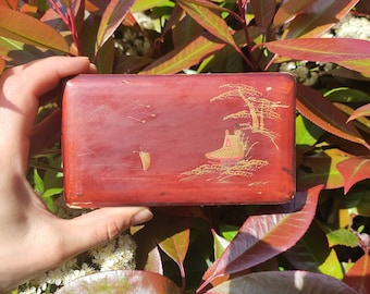 Antique Japanese lacquered paper maché box with a boat and a temple