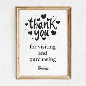 Może przedstawiać: Wydruk w ramie z tekstem "thank you" w czarnym piśmie odręcznym z sercami otaczającymi tekst. Tekst poniżej brzmi "for visiting and purchasing" ze słowem "Nostalgia" w mniejszej czcionce poniżej.