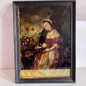 May include: An antique framed painting depicting a woman in a red and cream dress, seated and holding flowers. The painting has a dark background and a black frame. The word "May" is written at the bottom.