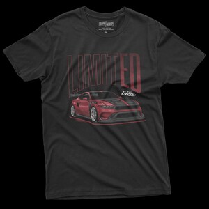 May include: Black t-shirt featuring a red sports car illustration with the text "LIMITED Edition" in a vertical font. The shirt has a crew neck and short sleeves. The graphic is detailed, showcasing the car's design.
