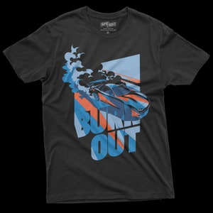 May include: A dark gray t-shirt with a blue and orange graphic of a car doing a burnout with smoke and the text "BURN OUT".
