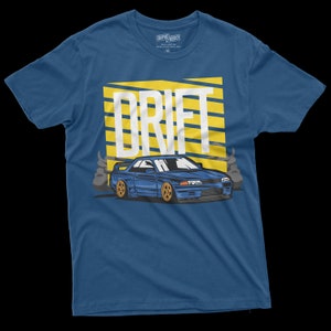 May include: A blue t-shirt with a yellow and white graphic of a car drifting with the word "DRIFT" above it.