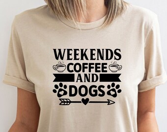 May include: A beige t-shirt with the text "Weekends Coffee and Dogs" in black. The text is accompanied by two coffee cup icons, a paw print icon, and an arrow with a heart.