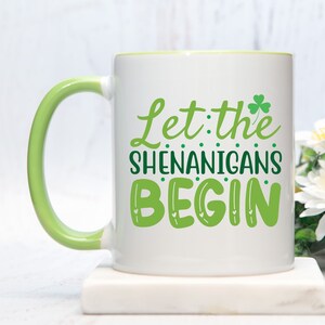 Let The Shenanigans Begin Mug | St Patrick&#39;s Day Coffee Mug | 11oz White Ceramic Cup | Green Handle And Interior | Funny St Paddy&#39;s Day Gift