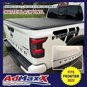 May include: Matte black vinyl decals for a Nissan Frontier pickup truck. The decals include bedside, tailgate, and front fascia inserts. The decals feature the word "Frontier" in a bold, black font.