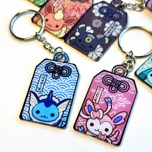Llavero Omamori de Eevee Evolution / Caja sorpresa de Pokémon
