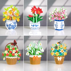 Könnte beinhalten: Eine Sammlung von floralen Papierkunst-Arrangements. Die Arrangements umfassen einen Zitronenbaum in einer blau-weißen Vase, rote Amaryllis, Kirschblüten, Erdbeeren in einem Korb mit einem Schmetterling, Schneeglöckchen und Narzissen mit Bienen.
