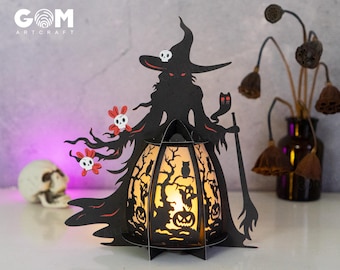 May include: A black papercraft witch silhouette with a glowing lantern. The lantern has a tree and owl design with a skull and crossbones at the top. The witch is holding a broom and a cat.