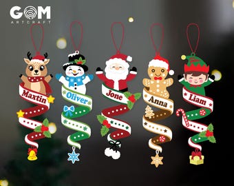May include: Five hanging Christmas ornaments featuring a reindeer, snowman, Santa Claus, gingerbread person, and elf. Each character holds a spiral ribbon printed with the names Maxtin, Oliver, Jone, Anna, and Liam, decorated with festive icons.