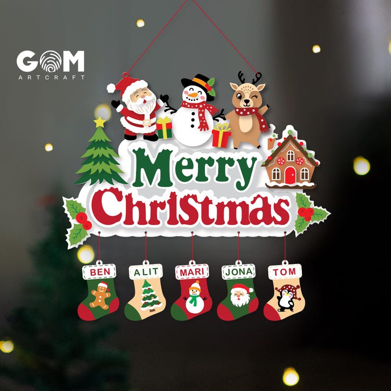 May include: A decorative Christmas wall hanging featuring a white sign with the text Merry Christmas in green and red. It includes illustrations of Santa, a snowman, a reindeer, a tree, and a house, with five hanging stockings labeled Ben, Alit, Mari, Jona, and Tom.