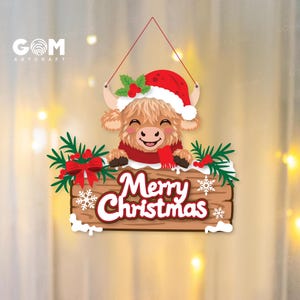 May include: A hanging wooden sign featuring a cartoon Highland cow wearing a red Santa hat and scarf. The sign displays the text Merry Christmas in white letters with a red outline, decorated with green pine branches, red berries, and white snowflakes.