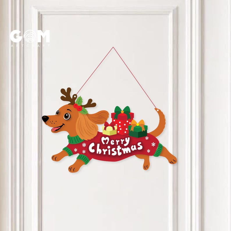 May include: A hanging wall sign featuring a brown dachshund wearing a green sweater and reindeer antlers. The dog carries three gift boxes on its back and the text Merry Christmas is printed in white on the red sweater with snowflake accents.
