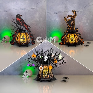 May include: Halloween-themed paper lanterns in black with orange and yellow interior lighting. One lantern features a raven, another a hand, and the third a tree with Halloween decorations. Skulls and spiders are also present.