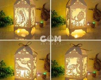 May include: Four white paper lanterns with intricate cut-out designs of sea creatures, including a jellyfish, a mermaid, a whale, and a turtle. Each lantern is illuminated from within, casting a warm glow.