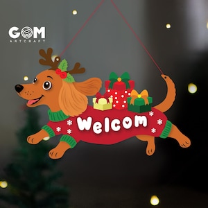 May include: A hanging sign shaped like a brown dachshund wearing a red sweater with green trim and white snowflake patterns. The dog has reindeer antlers with holly and carries three gift boxes. The text Welcom is printed in white on the sweater.
