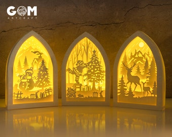 May include: Three white wooden arch-shaped light-up Christmas decorations. The first features a snowman, the second features Santa Claus, and the third features a deer.