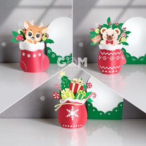 May include: Three Christmas paper cutouts. A deer in a red stocking, a bear in a red mitten, and a red bag with gifts. Each has a white background and green accents. Festive decorations for the holiday season.