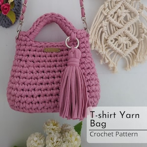 May include: A pink crocheted handbag with a long strap and a tassel. The bag is made from t-shirt yarn and has a small label that says "2-4-EVER". T-shirt Yarn Bag Crochet Pattern