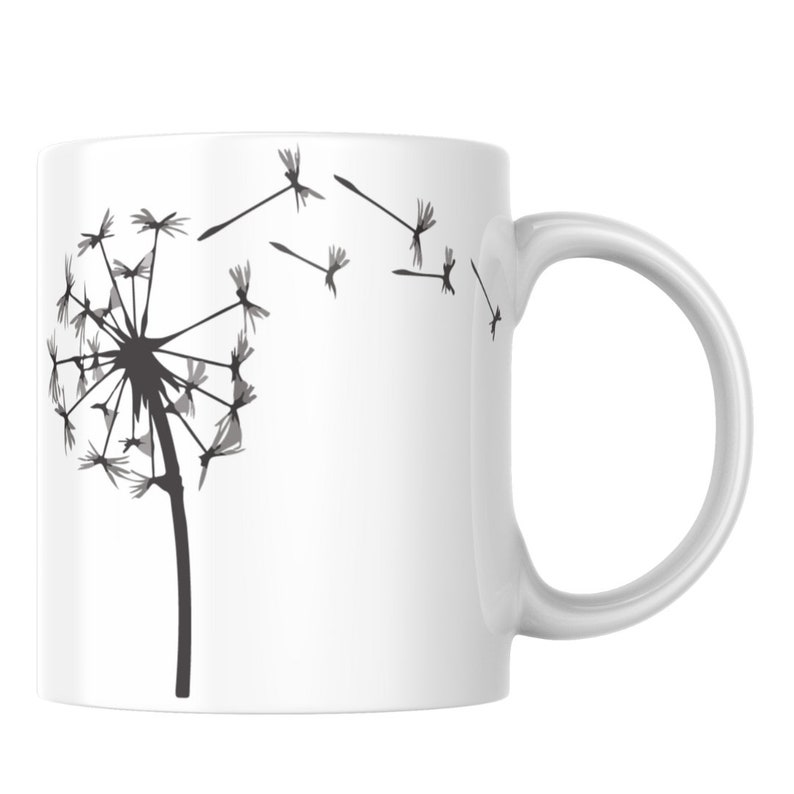 May include: White ceramic mug featuring a black and grey silhouette of a dandelion with seeds blowing in the wind.