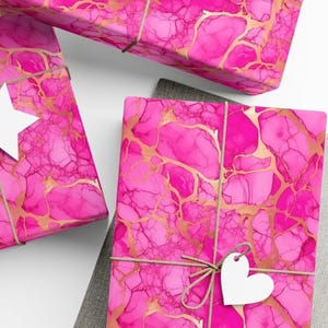 Hot pink gift wrap in an alcohol ink design.