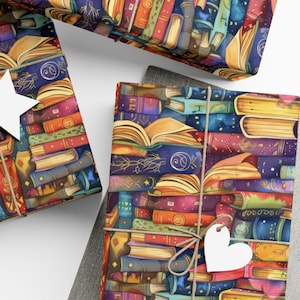 May include: Wrapping paper featuring a repeating pattern of stacked and open books in shades of blue, purple, orange, and yellow. The paper is tied with twine and includes a white heart-shaped gift tag attached to the front of the package.