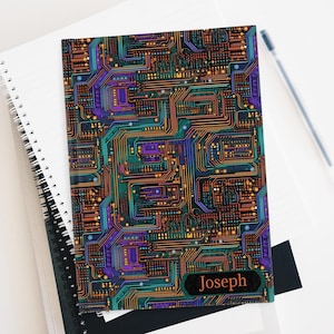 May include: A notebook with a colorful circuit board design and the name "Joseph" printed on the cover.