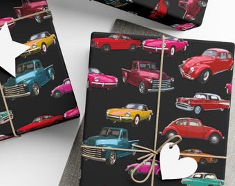 May include: Gift wrap featuring a pattern of vintage cars in various colors, including red, yellow, pink, and blue, on a black background. The wrapped gifts are tied with twine and a heart-shaped tag.