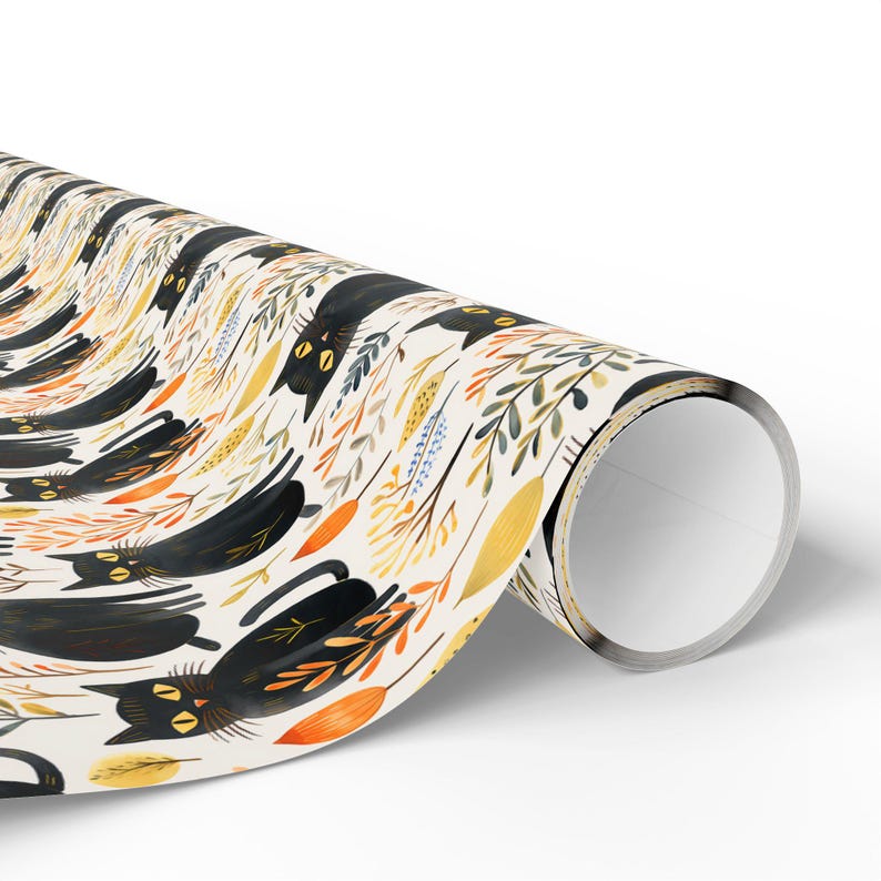 May include: Rolled wrapping paper featuring a repeating pattern of black cats and autumn foliage in shades of orange, yellow, and blue on a cream background. The cats are stylized with yellow eyes and are interspersed with leaves and sprigs.