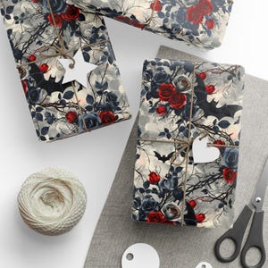 May include: Gift wrap featuring a dark, gothic design with red roses, bats, and a cloudy background.