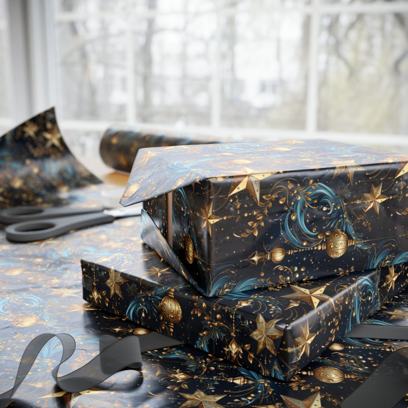 May include: Two gift boxes wrapped in black and gold patterned paper with blue accents. The boxes are stacked on top of each other and have a festive, holiday feel.