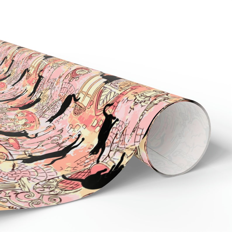 May include: Pink and yellow wrapping paper with a repeating pattern of black cats and whimsical illustrations. The paper is rolled up and the end is visible.