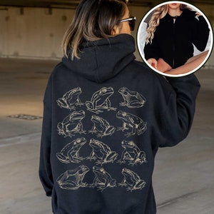 May include: Black hooded sweatshirt with a graphic print of 12 frogs in a line on the back. The frogs are outlined in white.