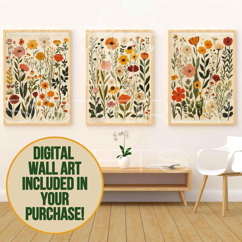 May include: Three framed floral art prints. Each print showcases a variety of colourful flowers in shades of red, orange, yellow, and pink, set against a cream background. The frames are a light wood colour. The text in the image says "DIGITAL WALL ART INCLUDED IN YOUR PURCHASE!"