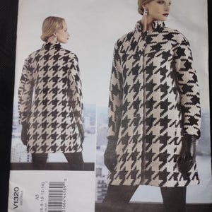 May include: Vogue pattern featuring an Issey Miyake design. The pattern shows a houndstooth coat with a high collar. The image includes a front and back view of the coat. The pattern number is V1320, and the size range is A5 (6-8-10-12-14).
