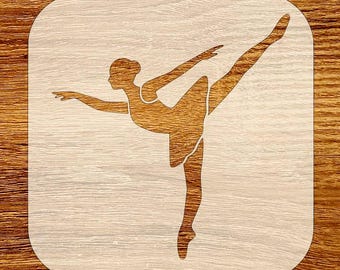 May include: A wooden stencil featuring a ballerina in a graceful pose. The dancer is depicted with one leg extended and arms outstretched, set against a light wood grain background. The design is cut out, creating a negative space effect.