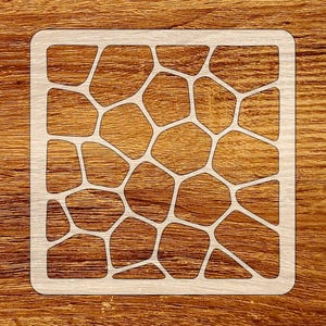 May include: A square, light-colored stencil with a geometric pattern of irregular shapes. The stencil is made of a light-colored material and is set against a wooden background. The design is reminiscent of a mosaic or a network of interconnected cells.