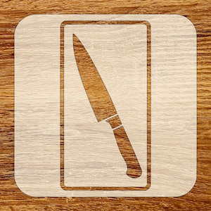 May include: A light-colored wooden cutting board with a knife design etched into it. The knife is depicted in a rectangular frame, showcasing the blade and handle. The wood grain is visible.