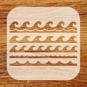 May include: A square stencil with rounded corners featuring four rows of wave patterns. The top three rows have a classic ocean wave design, while the bottom row has a simpler, more subtle wave pattern. The stencil is light-colored against a wood grain background.