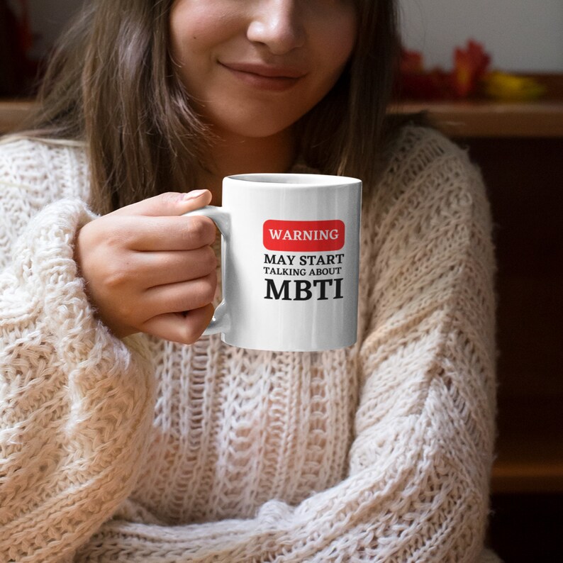 May include: White ceramic mug with a red warning sign that says "WARNING MAY START TALKING ABOUT MBTI".