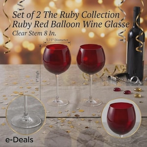 May include: A set of two ruby red balloon wine glasses from The Ruby Collection, each featuring a clear stem. The glasses measure 8 inches in height and 3.75 inches in diameter. The set includes two glasses with round bowls and clear bases.