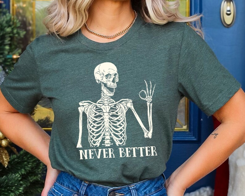 May include: A green t-shirt with a white skeleton graphic giving a thumbs up and the text "NEVER BETTER".