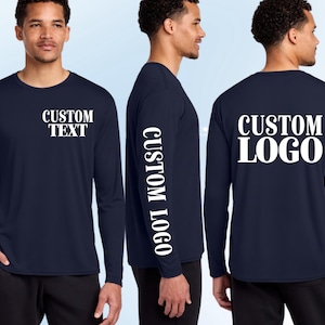 May include: A navy blue long-sleeve shirt featuring white text on the front left chest that reads CUSTOM TEXT, white text on the right sleeve that reads CUSTOM LOGO, and white text on the back that reads CUSTOM LOGO in a bold font.